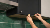 Black, Bold Cabinets And Dramatic Green Tiles Refresh This 2000S Kitchen